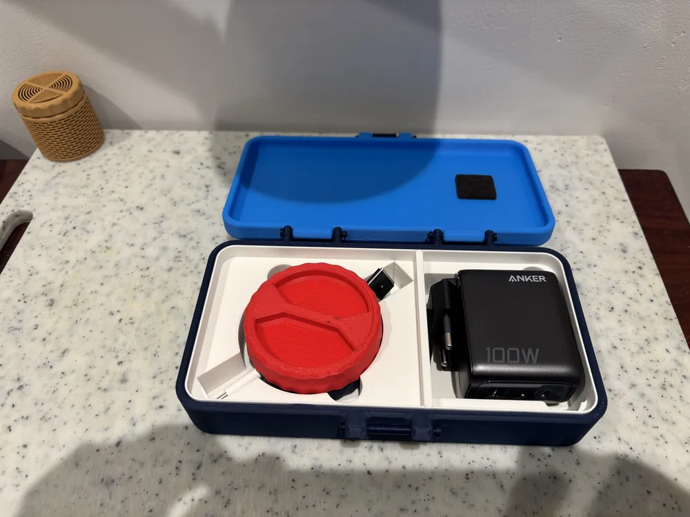 Blue two-tone case with a custom-fit insert holding a charger and cable reel